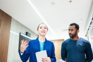 concierge medicine doctor and patient talking while walking in a medical clinic