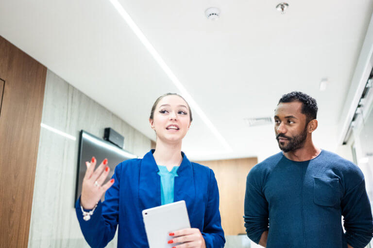 concierge medicine doctor and patient talking while walking in a medical clinic